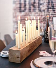 a table topped with lots of white candles