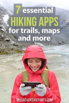 a woman in red jacket looking at her phone with text overlay that reads 7 essential hiking apps for trails, maps and more