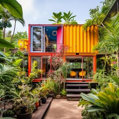 a house made out of shipping containers is surrounded by tropical plants and potted trees