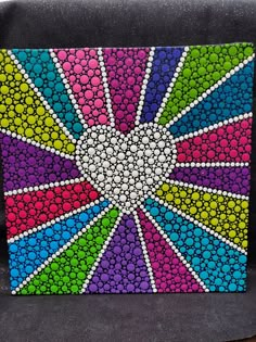 a colorful painting on the back of a car seat that has been painted with dots and circles