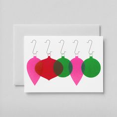 three christmas baubles on a white card with red, green and brown ornaments