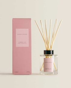 a pink box next to an open reed diffuser