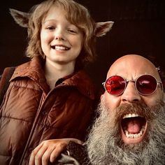 a young boy and an older man with red glasses