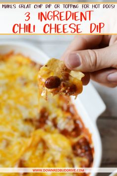 a hand holding a piece of cheesy chili cheese dip over a casserole dish