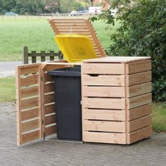 a trash can sitting in front of a wooden bench with a yellow plastic chair next to it