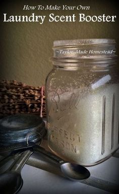 a mason jar filled with liquid next to spoons