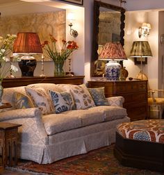 a living room filled with furniture and lamps