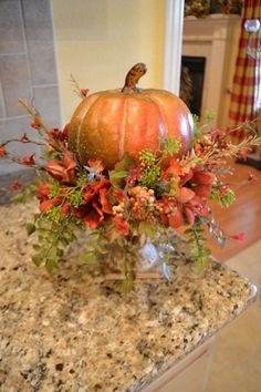 a vase filled with flowers sitting on top of a counter