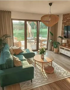 a living room filled with furniture and a flat screen tv on top of a wooden floor