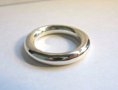 This is a very simple round band. I have been making these for years. As long as people still want this ring, I will continue to make them. They are great to wear in groups of two or even three. They also make great thumb rings.  I make this ring in all metals and any size that you need.  The ring is made of sterling silver. It is 4mm round stock. Minimal Rings Minimalist Jewelry, Minimal Rings, Gold Thumb Rings, Stone Jewelry Necklace, Rings Minimalist, Donut Ring, Chunky Silver Rings, Minimal Ring, Artisan Rings