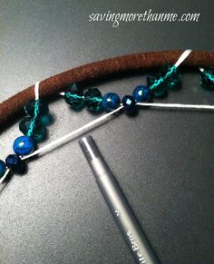 a crochet hook with blue beads on it