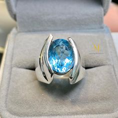 Ring Details - Natural Swiss Blue Topaz - Main Stone Size: 12.00x10.00mm (Approximate) - Ring Front Width: 15.5mm - Band Width: 5.8mm - Band Thickness: 2.00mm - Gross Weight: 15.00 grams - Handmade Ring - Sterling Silver 925, Hallmarked - Dimensions and Weight Depend on Variations in Sizes. - Available in all Sizes (Please ensure accurate ring sizing) - DM for Customizations **Note - Our Products are Made to Order According to Customer Expectations, So It May Take Some Time. We Work on Our Produ Fine Jewelry Blue Topaz Ring, Sapphire-colored Topaz Gemstone Ring, Sapphire-colored Topaz Ring, Fine Jewelry Light Blue Topaz Ring, Modern Blue Topaz Round Ring, White Gold Topaz Gemstone Ring, White Gold Topaz Ring With Gemstone, Modern Round Blue Topaz Ring, Modern Blue Topaz Ring With Accent Stones