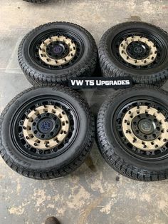 four black and white wheels are sitting on the ground