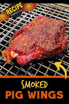 a piece of meat is cooking on a grill with the words smoked pig wings above it