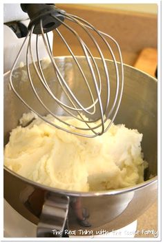 a mixer filled with mashed potatoes on top of a counter