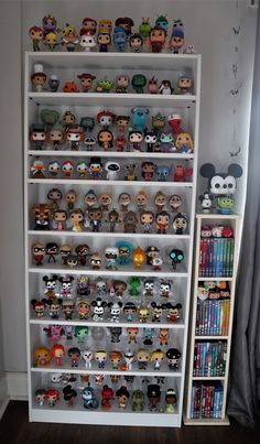 a book shelf filled with lots of different kinds of pop vinyls on top of it