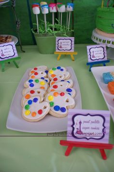 a table topped with lots of cakes and desserts