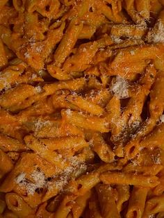 a close up view of some pasta with parmesan cheese on top