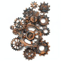 an assortment of rusty gears on a white background