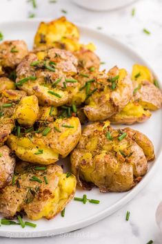 garlic smashed potatoes on a white plate