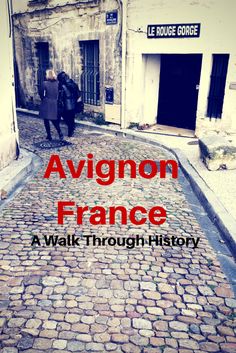 an old cobblestone street with the words avlon france in red on it