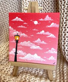 an easel with a painting of a street light