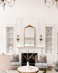 a living room filled with furniture and a fire place in front of a white fireplace