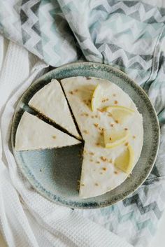 a slice of cake on a plate with lemons next to it and a towel