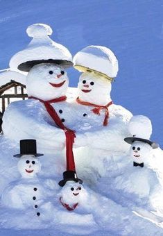 a group of snowmen with hats and scarfs