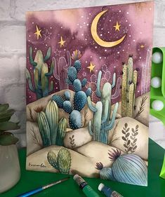 a card with cactus and stars on it next to a potted cacti