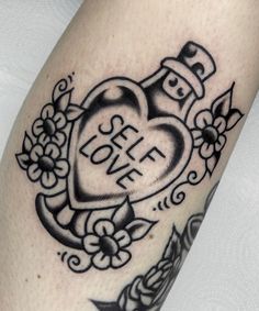 a black and white photo of a heart tattoo