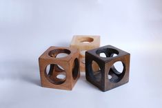 three wooden cubes sitting next to each other on a white surface