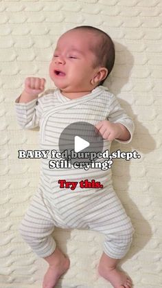 a baby laying on top of a bed with the caption saying, baby i'd turned sleep still crying? try this