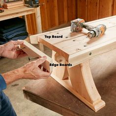 a person working on a wooden bench with two drill holes in the top and bottom