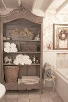 an old fashioned bathroom is decorated in white and beige colors, with antique decor on the shelves