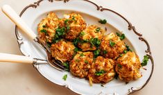 a white plate topped with meatballs covered in parsley