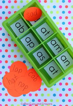 a green tray with letters and numbers in it on a polka dot tablecloth background