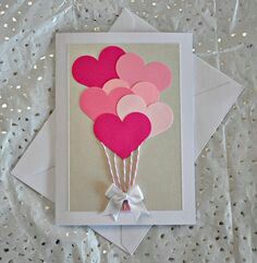 a card with pink and red balloons on it