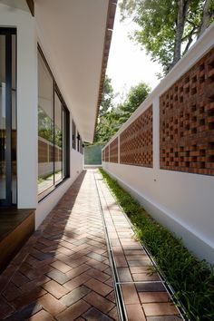 the walkway is lined with brick and grass