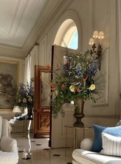 a living room filled with furniture and flowers