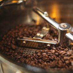 a coffee grinder filled with lots of coffee beans