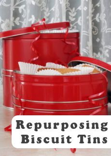 two red tins with the words repurposing biscuit tins on them