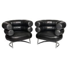 two black leather chairs sitting next to each other