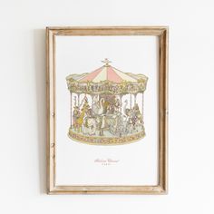 an old fashioned merry go round with horses and people on it, framed in a wooden frame