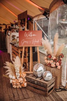 there is a sign that says welcome to the guests at this outdoor wedding reception,