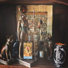 a shelf with statues and other items on it