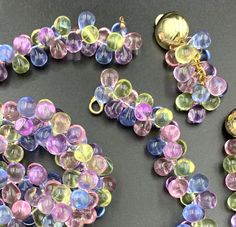 several different colored glass beads on a table