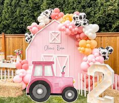 an animal themed birthday party with farm animals and balloons in front of a barn door