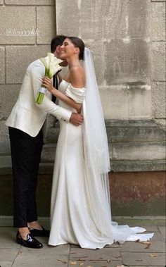 a bride and groom standing next to each other