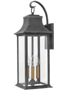 an outdoor wall light with two candles on it